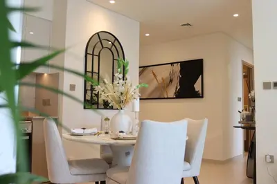 a dining room with a white table and chairs at Burj Royale Residences Downtown Dubai - Burj Khalifa District in Dubai