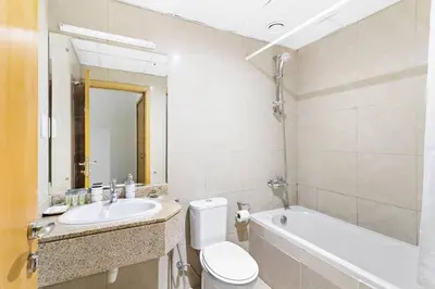 a bathroom with a toilet and a sink and a tub at StoneTree - Marina Crown 1 BR - Dubai Marina in Dubai