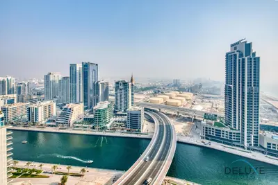 an aerial view of a city with a river and buildings at Stylish 1BR in Prime Location, Book Your Stay by Deluxe Holiday Homes in Dubai
