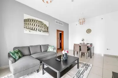 a living room with a couch and a table at StoneTree - Marina Pinnacle 1 BR - Partial Marina View in Dubai