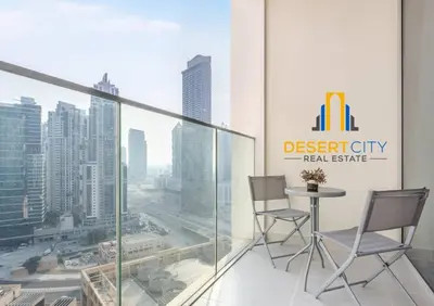 a table and chairs in a room with a view of a city at Fully Furnished 1 Bed in Downtown Dubai, Hosted by Desert City Stays in Dubai
