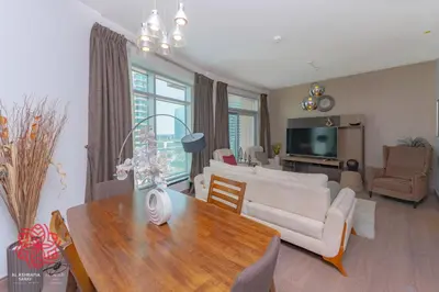 a living room with a table and a couch at Alashrafia Saray- Central 2BR apartment in Downtown in Dubai