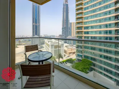 a balcony with a table and a view of a city at Alashrafia Saray- Central 2BR apartment in Downtown in Dubai