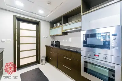 a kitchen with a stainless steel oven and cabinets at Alashrafia Saray- Central 2BR apartment in Downtown in Dubai