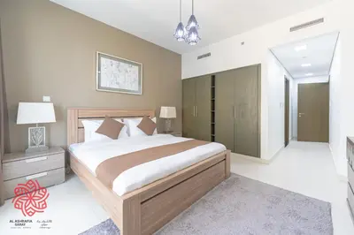 a bedroom with a large bed and a room with at Alashrafia Saray- Central 2BR apartment in Downtown in Dubai