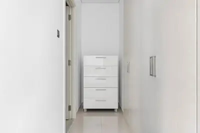 a white hallway with a dresser in a room at StoneTree - Pelham Villa 3 BR - Damac Hills in Dubai