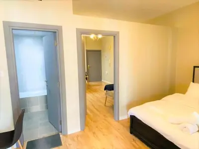 a bedroom with a bed and a door leading to a hallway at Royal Manor- Marina Diamond 2 in Dubai