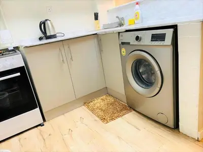 a kitchen with a washing machine in a kitchen at Royal Manor- Marina Diamond 2 in Dubai