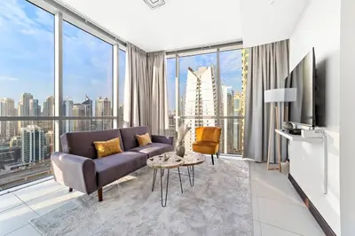 a living room with a couch and a large window at StoneTree - Indigo Tower 1BR - Panoramic View in Dubai