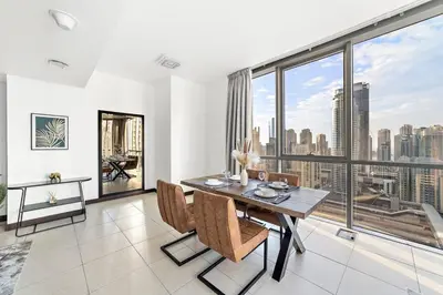 a dining room with a view of the city at StoneTree - Indigo Tower 1BR - Panoramic View in Dubai