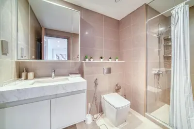 a bathroom with a toilet and a sink and a shower at Burj Royale, Downtown Dubai - Mint Stay in Dubai