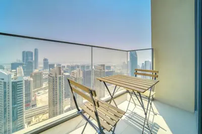 a balcony with a wooden table and two chairs at Burj Royale, Downtown Dubai - Mint Stay in Dubai