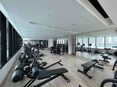 a gym with a lot of exercise equipment in a building at Trophy Amazing Burj Khalifa Views from This Stylish Condo in Dubai