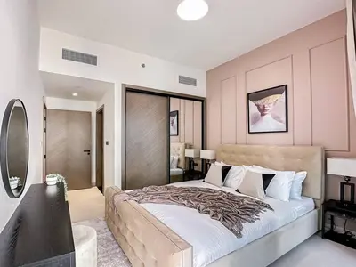 a bedroom with a large bed and a television at Trophy Amazing Burj Khalifa Views from This Stylish Condo in Dubai