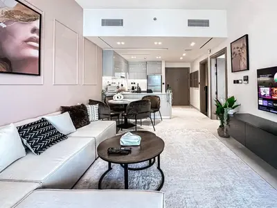 a living room with a couch and a table at Trophy Amazing Burj Khalifa Views from This Stylish Condo in Dubai