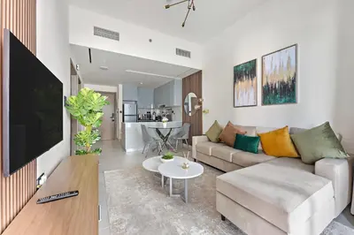 a living room with a couch and a table at WelHome - Contemporary 1BR in Binghatti Canal & Burj Views in Dubai