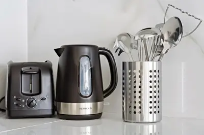 a kitchen counter with a coffee maker and a blender at WelHome - Contemporary 1BR in Binghatti Canal & Burj Views in Dubai