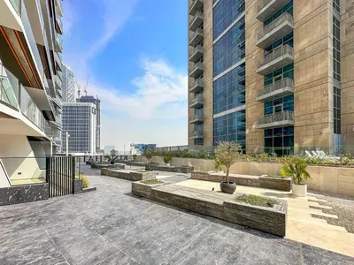 a row of benches in front of a building at WelHome - Contemporary 1BR in Binghatti Canal & Burj Views in Dubai