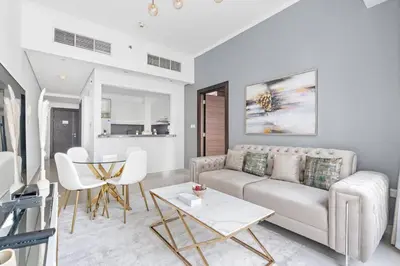 a living room with a couch and a table at StoneTree - Modern 1BR near Dubai Marina Mall in Dubai