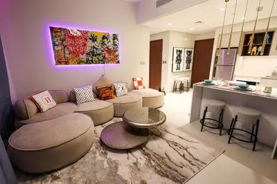 a living room with a couch and a table at VIDA Premier Deluxe - Creek Beach - Beachfront Bliss in Dubai