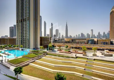 a view of a city with a pool and buildings at Walk to Dubai Mall 2 Bed Full Burj Khalifa Views in Dubai