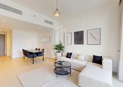 a living room with a white couch and a table at Walk to Dubai Mall 2 Bed Full Burj Khalifa Views in Dubai