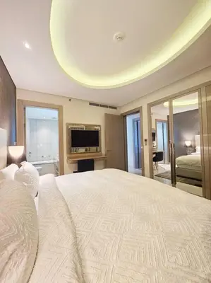 a large bedroom with a large bed and a television at Luxury Paramount Hotel Apt D111 in Dubai