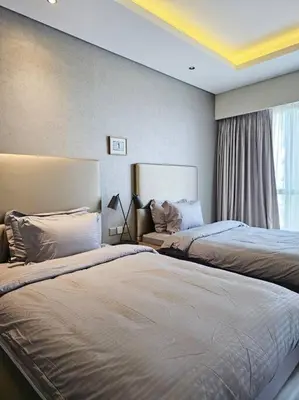 a hotel room with two beds and a window at Luxury Paramount Hotel Apt D111 in Dubai