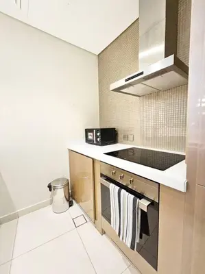 a kitchen with a sink and a stove top oven at Luxury Paramount Hotel Apt D111 in Dubai