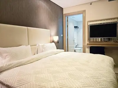 a bedroom with a large bed and a flat screen tv at Luxury Paramount Hotel Apt D111 in Dubai