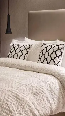 a white bed with pillows and a laptop on it at Luxury Paramount Hotel Apt A662 in Dubai
