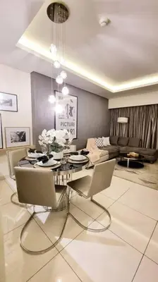 a living room with a table with chairs and a couch at Luxury Paramount Hotel Apt A662 in Dubai
