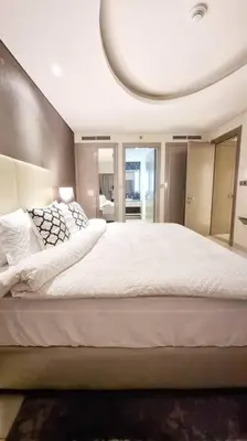 a bedroom with a large white bed with a round ceiling at Luxury Paramount Hotel Apt A662 in Dubai