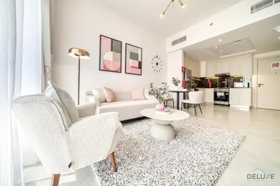 a living room with a couch and a table at Timeless 1BR at Binghatti Avenue Al Jaddaf by Deluxe Holiday Homes in Dubai