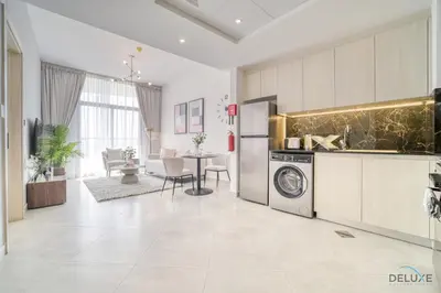 a kitchen with a washing machine and a dining room at Timeless 1BR at Binghatti Avenue Al Jaddaf by Deluxe Holiday Homes in Dubai