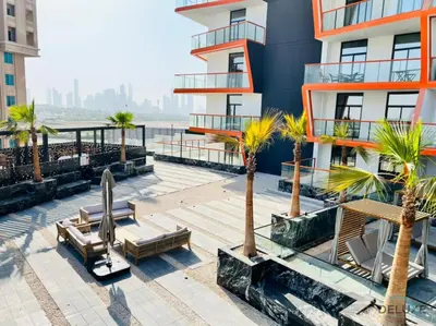 a building with benches and palm trees in front of it at Timeless 1BR at Binghatti Avenue Al Jaddaf by Deluxe Holiday Homes in Dubai