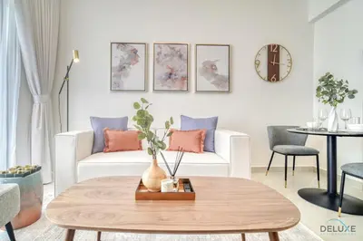 a living room with a white couch and a table at Soothing 1BR at Binghatti Avenue Al Jaddaf by Deluxe Holiday Homes in Dubai