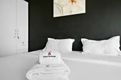 a white towel sitting on top of a bed at StoneTree - Cozy Fully-Furnished Studio in JLT in Dubai