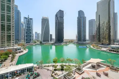 a large body of water in a city with tall buildings at StoneTree - 1BR apartment with Lake View in Dubai