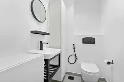 a bathroom with a sink and a toilet and a mirror at StoneTree - Stylish Apartment with amazing building facilities in Dubai