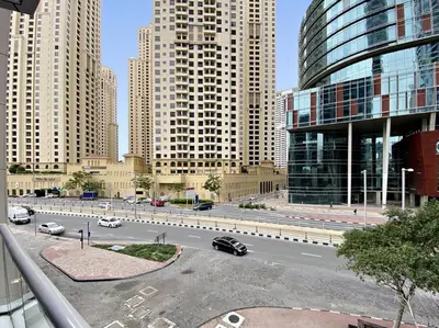 a city with tall buildings and a street with cars at StoneTree - Stylish Apartment with amazing building facilities in Dubai