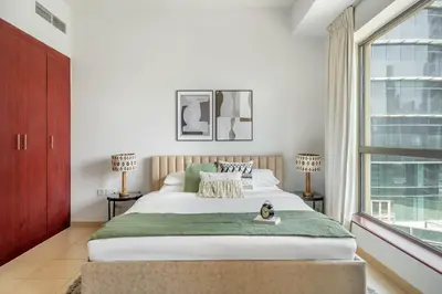 a bedroom with a large bed and a window at GuestReady - Luxurious Marina view residence in Dubai