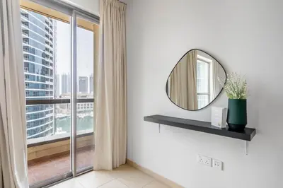 a bathroom with a mirror and a large window at GuestReady - Luxurious Marina view residence in Dubai