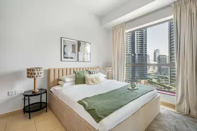 a bedroom with a large bed and a large window at GuestReady - Luxurious Marina view residence in Dubai