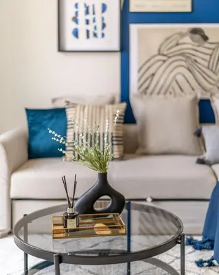 a living room with a glass table and a couch at GuestReady - Luxurious Marina view residence in Dubai
