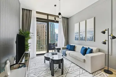 a living room with a couch and a table at StoneTree - Modern Living in Dubai Marina in Dubai