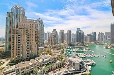 a view of a city with boats in a harbor at StoneTree - Modern Living in Dubai Marina in Dubai