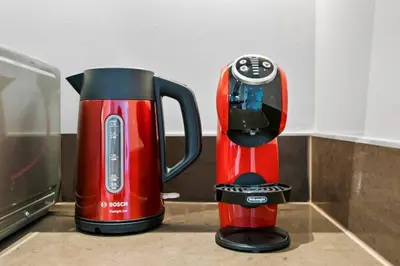 two red and black appliances sitting next to each other at StoneTree - Modern Living in Dubai Marina in Dubai