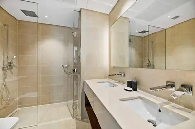 a bathroom with two sinks and a shower at StoneTree - Modern Living in Dubai Marina in Dubai