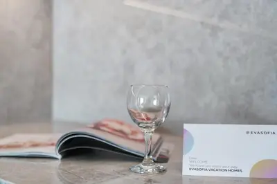 a wine glass sitting on a table next to a book at Sea view 2-Bedroom - Beach Isle in Dubai